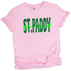 Pink St. Paddy Baddie t-shirt flat lay showcasing fun contrast lettering with bold green accents for a playful holiday look