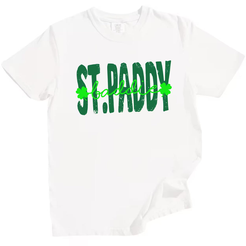 White St. Paddy Baddie t-shirt flat lay highlighting vibrant green lettering and fun mixed-font St. Patrick’s Day design