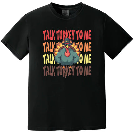 Black Thanksgiving graphic t-shirt featuring ‘Talk Turkey to Me’ text with a cool turkey wearing sunglasses and muscular arms cartoon design for festive holiday wear.