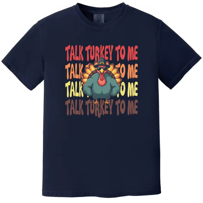 Navy blue Thanksgiving graphic tee with ‘Talk Turkey to Me’ slogan and sunglasses-wearing turkey illustration in a bold cartoon style holiday design.
