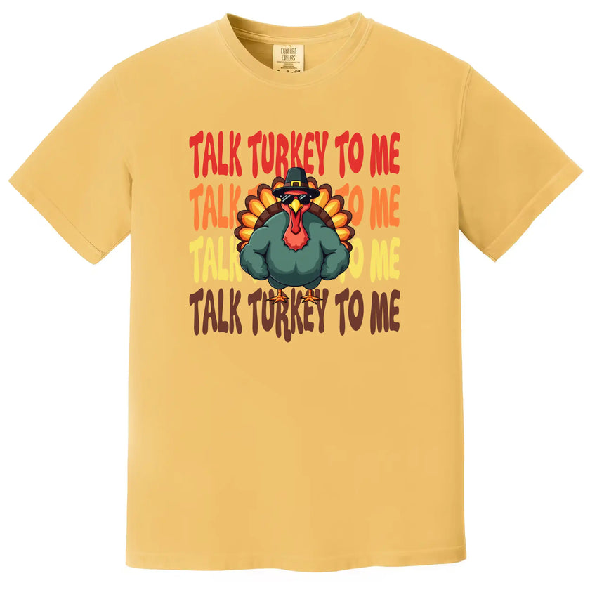 Yellow Thanksgiving graphic tee with ‘Talk Turkey to Me’ design featuring cool turkey wearing sunglasses and big muscle arms illustration for holiday season wear.