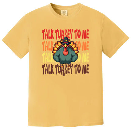 Yellow Thanksgiving graphic tee with ‘Talk Turkey to Me’ design featuring cool turkey wearing sunglasses and big muscle arms illustration for holiday season wear.