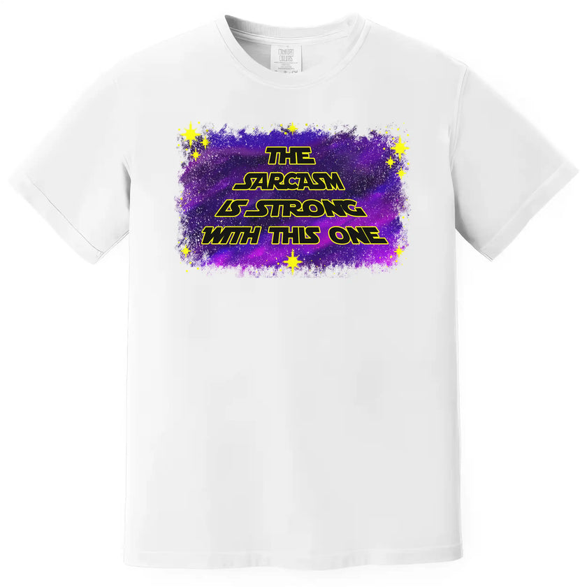 Funny space-themed t-shirt in white, ‘The Sarcasm Is Strong With This One’ text over galaxy design with yellow outlined lettering.