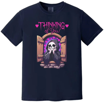 Dark humor graphic tee in navy, cute grim reaper leaning from castle window with hearts, ‘Thinking of You’ design.