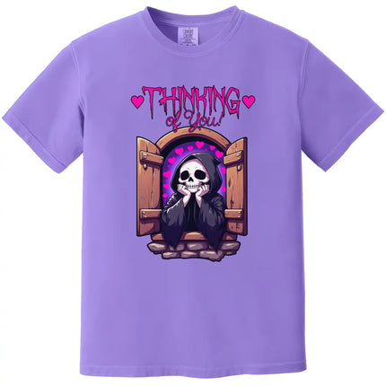 Grim reaper graphic t-shirt in purple, castle window scene with hearts and ‘Thinking of You’ text, cute sarcastic style.