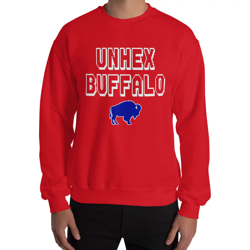 Man wearing a red Buffalo sports sweatshirt featuring the funny ‘Unhex Buffalo’ design with white pixel lettering and a blue buffalo graphic, showing hopeful Buffalo football and hockey spirit.