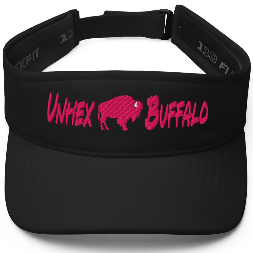Women’s Buffalo sports black golf visor featuring hot pink ‘Unhex Buffalo’ lettering with a hot pink buffalo silhouette between the words, bold fan style.
