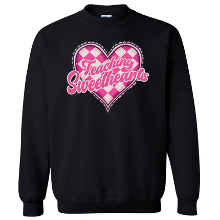 Black sweatshirt flat lay with “Teaching Sweethearts” lettering and retro pink heart design, teacher gift idea