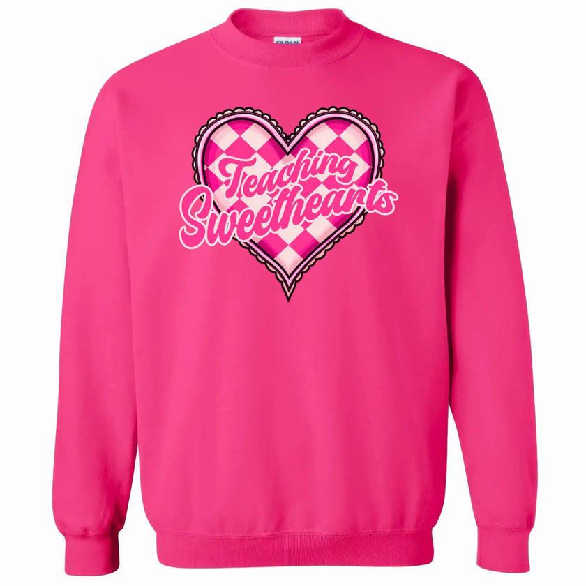 Hot pink sweatshirt flat lay with “Teaching Sweethearts” text, cute Valentine’s heart design for teachers
