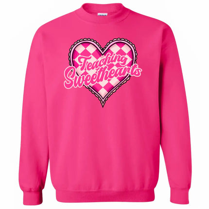 Hot pink sweatshirt flat lay with “Teaching Sweethearts” text, cute Valentine’s heart design for teachers