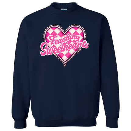 Navy sweatshirt flat lay featuring “Teaching Sweethearts” text and charming pink and white heart design