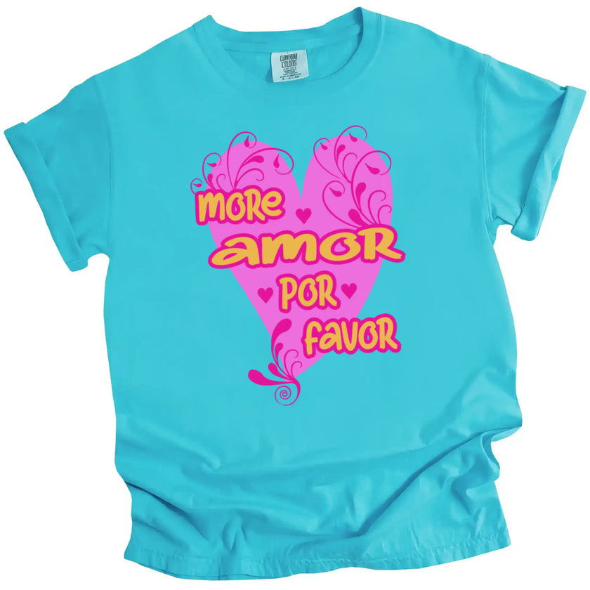 Turquoise More Amor Por Favor Valentine’s tee with hot pink heart and bold orange lettering, flat lay on white background.
