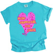 Turquoise More Amor Por Favor Valentine’s tee with hot pink heart and bold orange lettering, flat lay on white background.