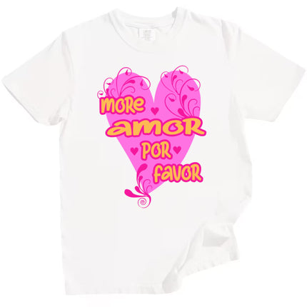 White More Amor Por Favor Valentine’s t-shirt with striking pink heart and fun orange typography, flat lay on white background.