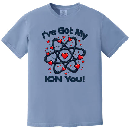 Blue “I’ve Got My Ion You” chemistry Valentine shirt flat lay with playful science graphic and heart design.