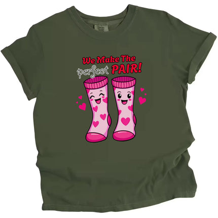 We Make the Perfect Pair socks Valentine’s t-shirt, green shirt flat lay, cute love-themed graphic, unisex fun tee for couples and Valentine’s gifting
