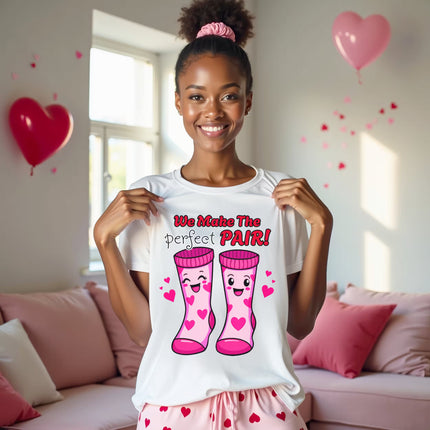 We Make the Perfect Pair t-shirt worn by woman in living room, white shirt, Valentine socks graphic, playful unisex design, perfect for Valentine’s Day