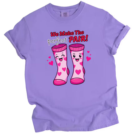 We Make the Perfect Pair Valentine tee, purple shirt flat lay, cute love-themed socks graphic, unisex Valentine’s Day shirt for couples or gifting