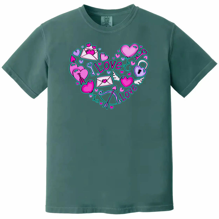 Teal shirt flat lay on white background showing whimsical Valentine’s heart doodles, letters, and balloons.