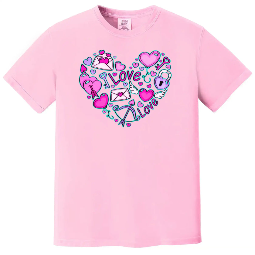 Pink shirt flat lay on white background capturing Valentine’s doodle heart with playful keys, arrows, and hearts.
