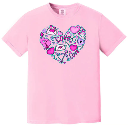 Pink shirt flat lay on white background capturing Valentine’s doodle heart with playful keys, arrows, and hearts.