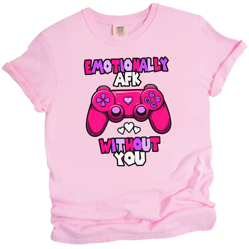 Pink “Emotionally AFK” Valentine’s tee with fun game controller graphic, flat lay with soft lighting.