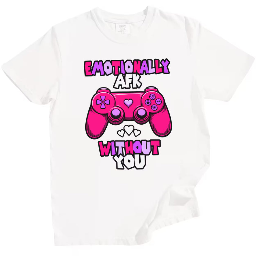 White “Emotionally AFK” gamer shirt with hot pink hearts and controller, flat lay on clean white backdrop.