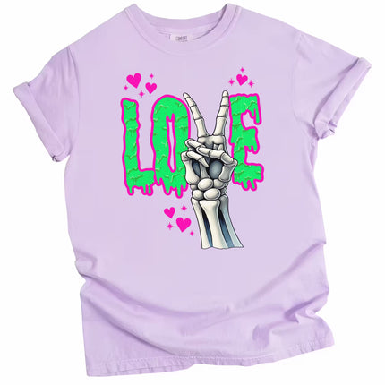 Gothic LOVE graphic tee flat lay in light purple with skeleton peace sign and vibrant dripping letters.