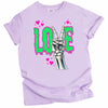 Gothic LOVE graphic tee flat lay in light purple with skeleton peace sign and vibrant dripping letters.