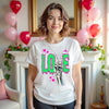 Female model wearing white Gothic Valentine’s LOVE t-shirt standing in her living room.