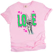 Valentine’s Gothic LOVE t-shirt flat lay in pink with edgy skeleton hand peace sign and green dripping letters.