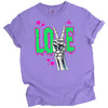 Gothic LOVE t-shirt flat lay in purple featuring skeleton peace sign and bright dripping green Valentine’s design.