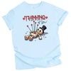 Thinking of You t-shirt with voodoo doll graphic, blue shirt flat lay, playful gothic Valentine’s aesthetic, women’s graphic tee for Valentine’s Day gifting