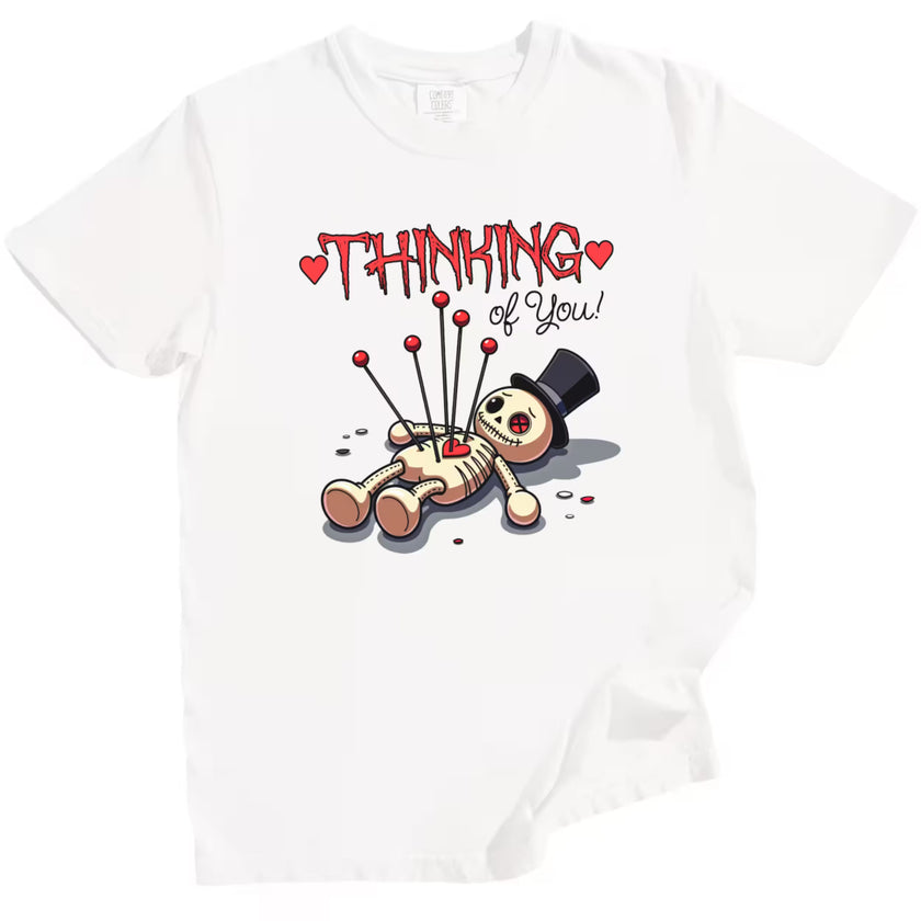Thinking of You t-shirt with voodoo doll illustration, white flat lay, minimalist Valentine’s aesthetic, romantic graphic tee