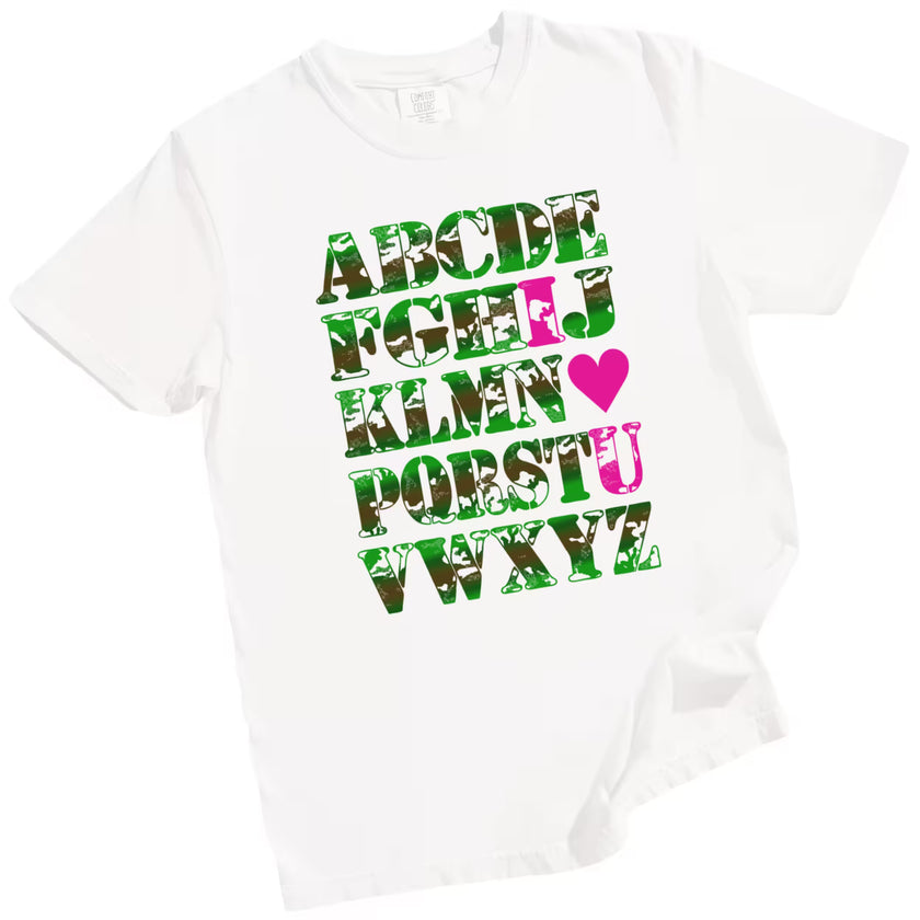 White “I ♥ U” Valentine’s tee flat lay, camo alphabet letters, romantic pun