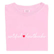 Pink Certified Heartbreaker tee with red heart flat laid on white background.