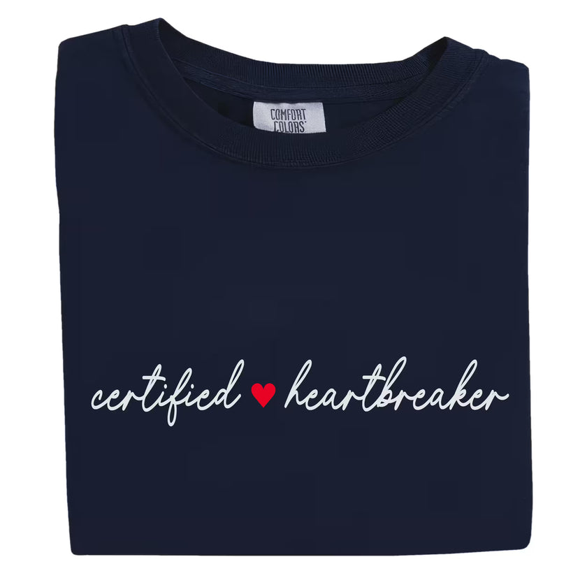 Navy Certified ♥ Heartbreaker shirt flat laid on white, featuring flirty red heart design and fancy font.