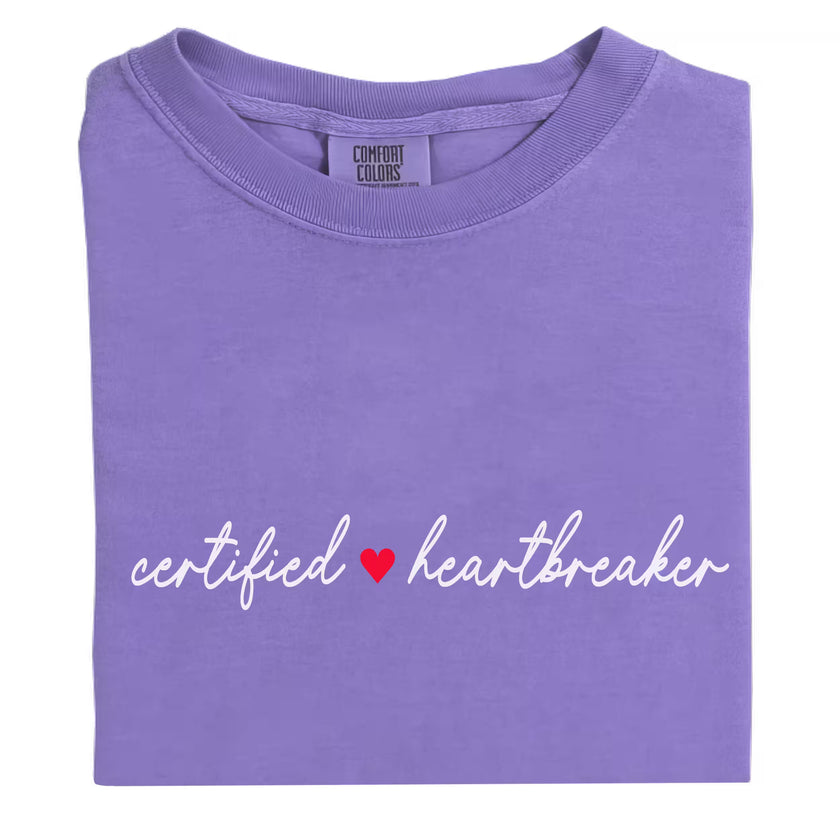 Purple minimalist Certified ♥ Heartbreaker shirt flat laid on white background.