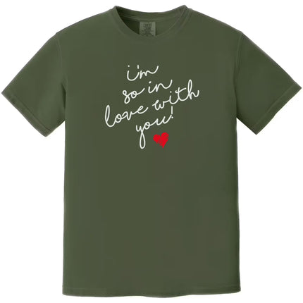 Green “I’m So In Love With You” t-shirt featuring handwritten text and red heart accent, playful love design for casual romantic outfits