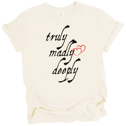 Cream Truly Madly Deeply t-shirt flat lay on white background with bold black lettering and red heart, romantic graphic tee for Valentine’s Day.