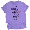 Purple Truly Madly Deeply t-shirt flat lay with bold vertical lettering and heart detail, fun love-themed women’s tee.