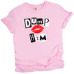 Light pink “Dump Him” tee flat lay on white background, bold black and white letters with red lips graphic.