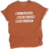 Orange “Well-Behaved Women Seldom Make History” t-shirt flat lay highlighting empowering feminist message with clean typography