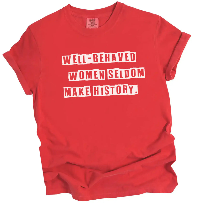 Red “Well-Behaved Women Seldom Make History” t-shirt flat lay featuring bold lettering and funny feminist statement for women