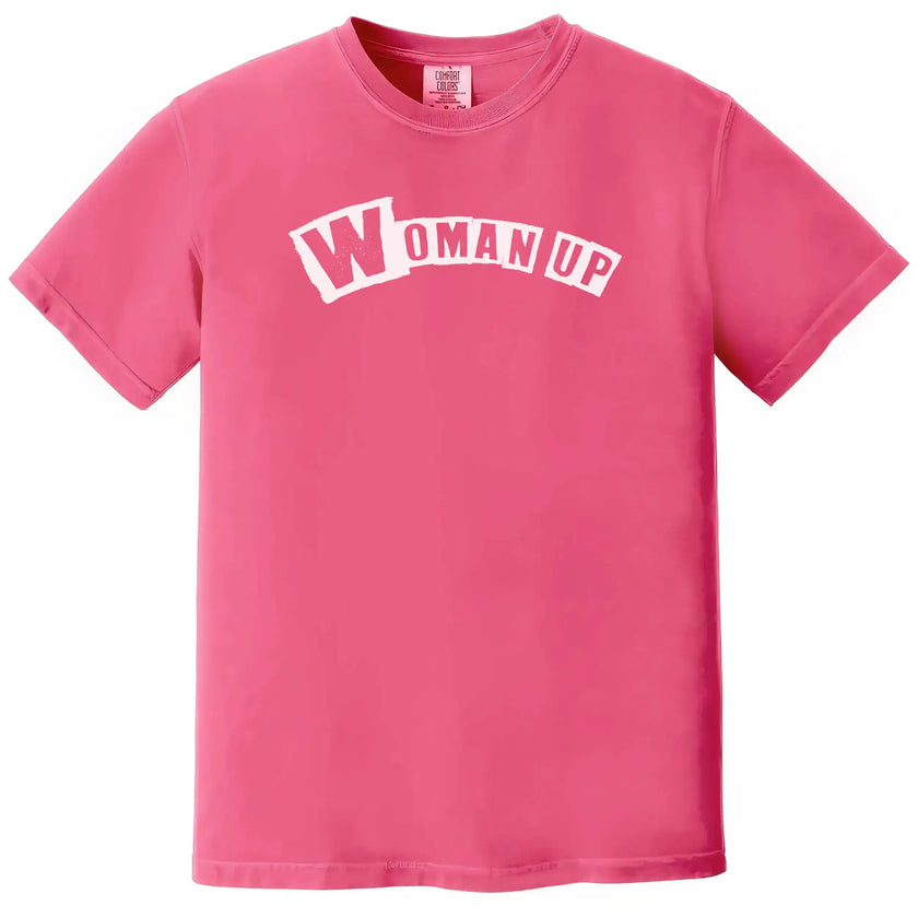 Pink “Woman Up” t-shirt flat lay with playful feminine color and strong girls-supporting-girls message