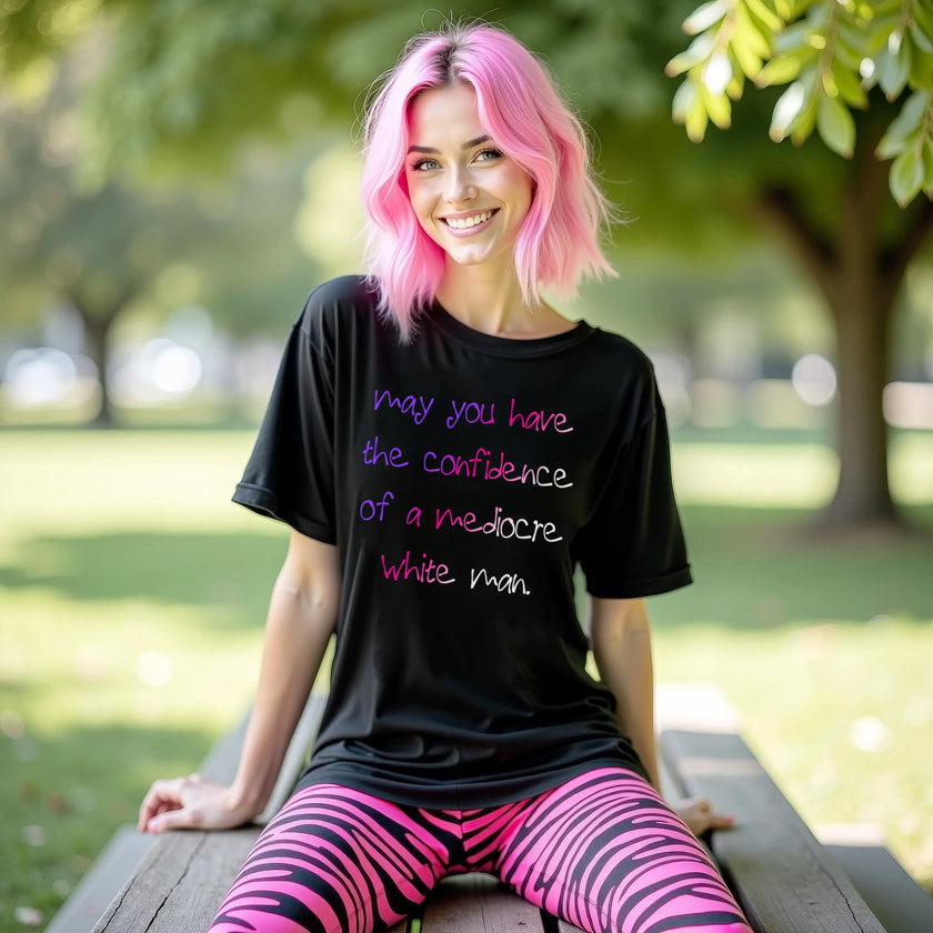 Model wearing black “May You Have the Confidence of a Mediocre White Man” t-shirt, casual lifestyle photo emphasizing confident feminist style